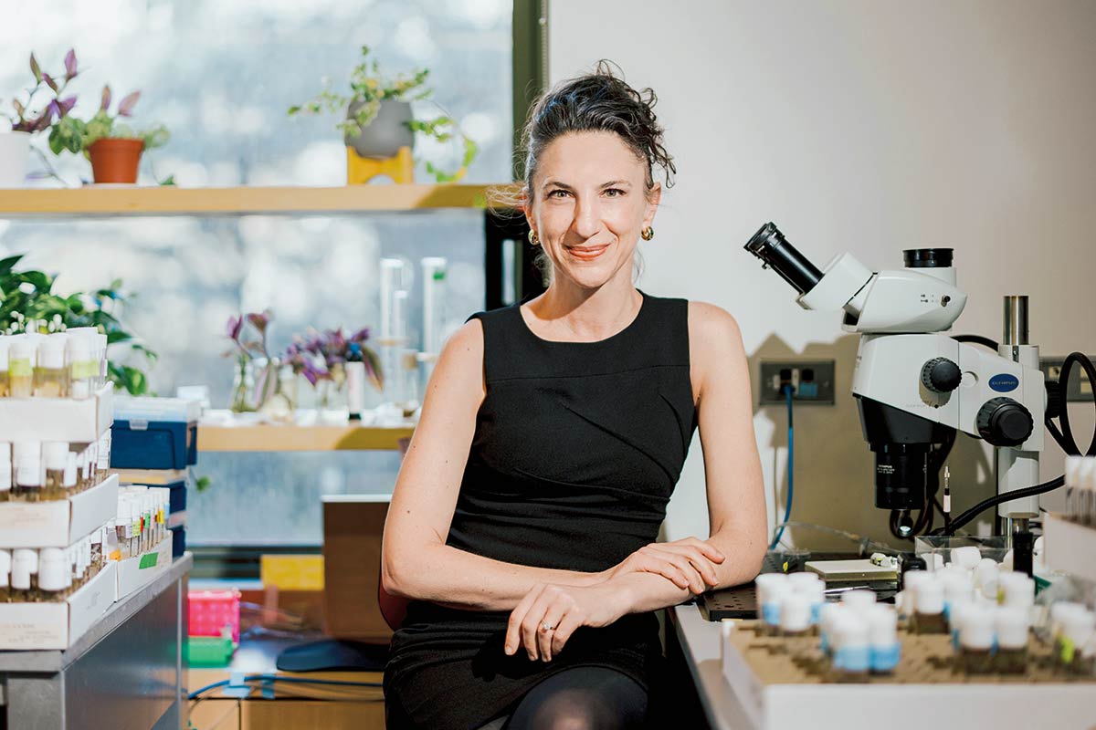 Ruta smiles in front of a microscope