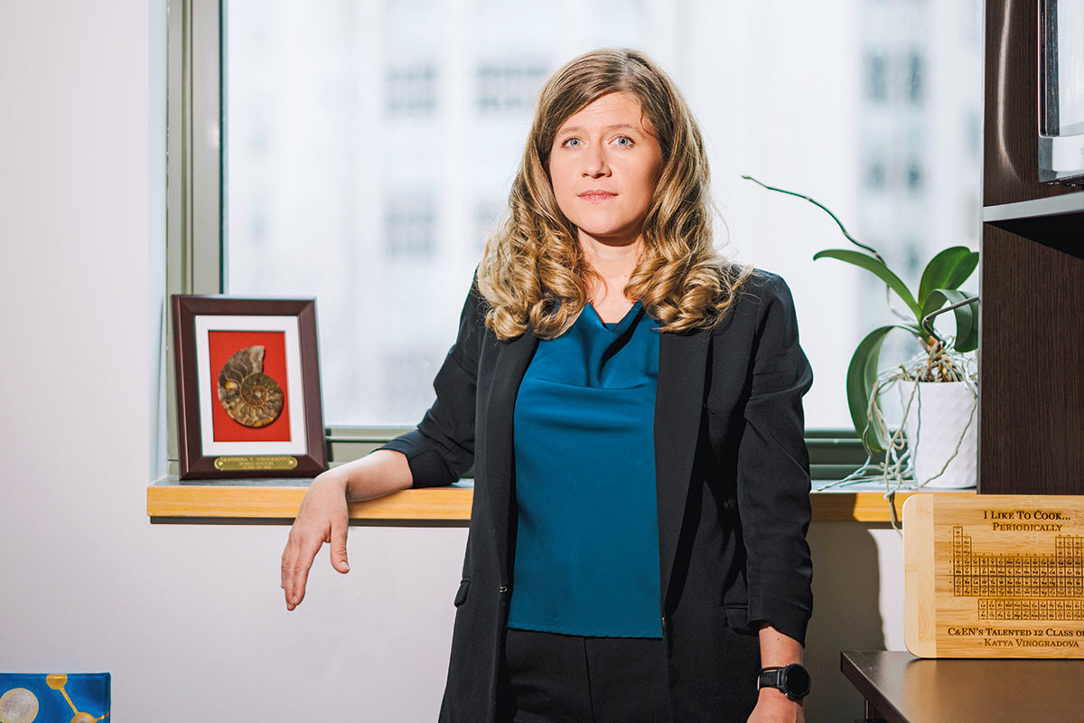 Vinograndova leans against a shelf in their office