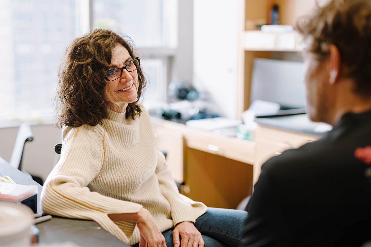 De Lange talks with a colleague