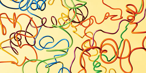 Twisted multicolored wires on a yellow background